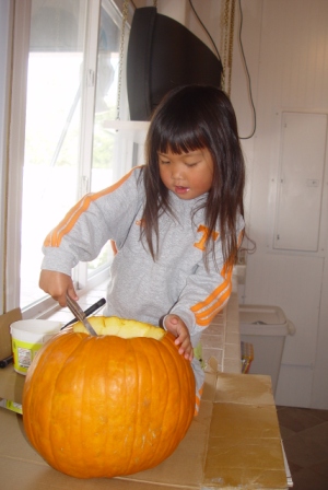 Kasen cleaning out the pumpkin
